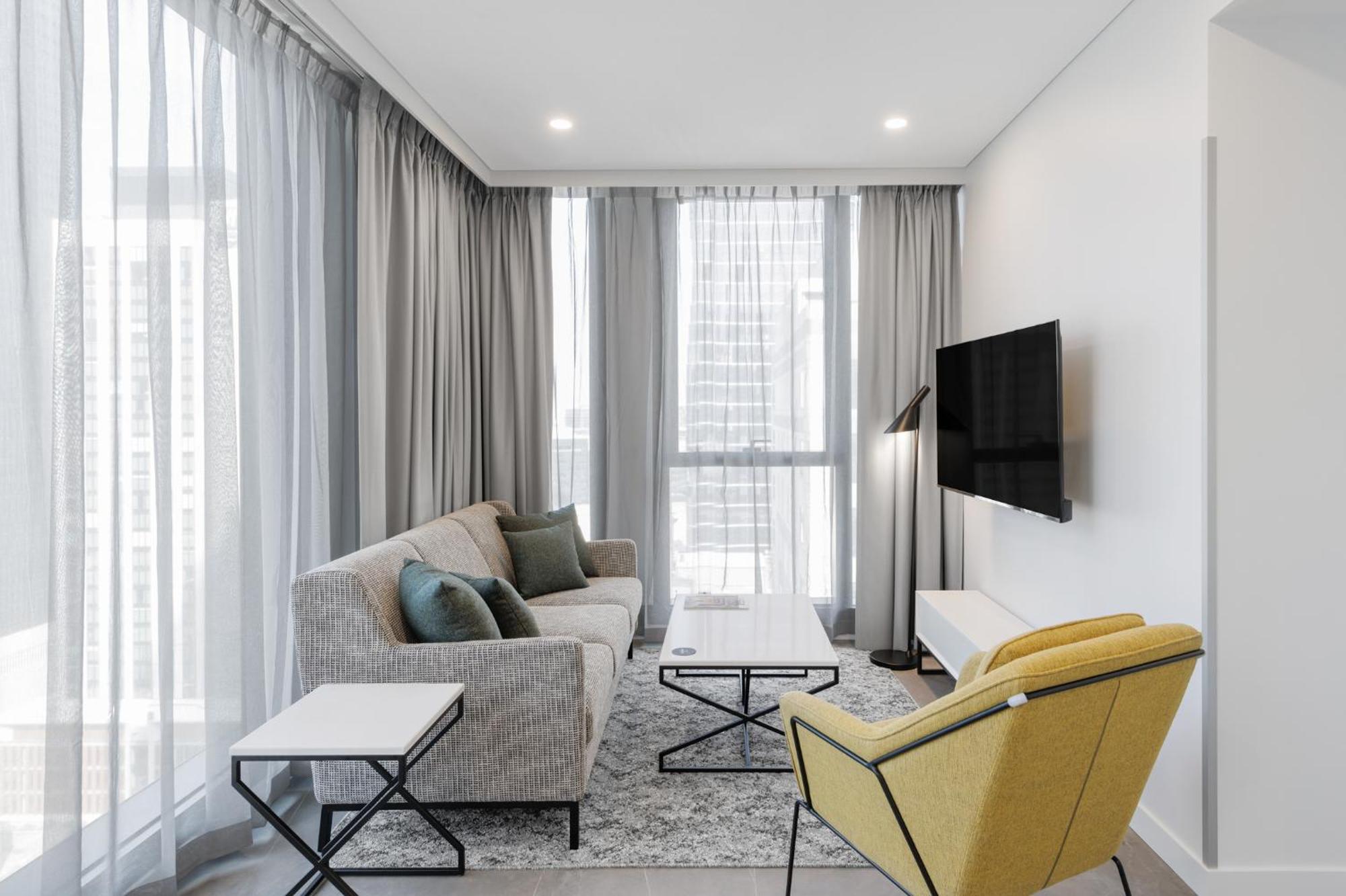 Meriton Suites Melbourne City Exterior foto A living room in a typical apartment